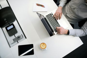 person-using-laptop-on-white-wooden-table.jpg person using laptop on white wooden table